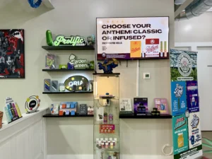 Display of cannabis products with promotional signage and shelves in a retail setting