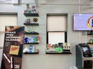Display of merchandise including vape products, promotional banners, and shelves with toys
